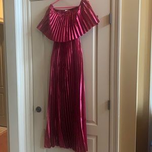 A pleated wine colored formal length dress on or off shoulder wear